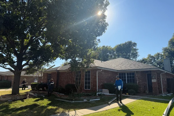Roofing contractor applying final touches to a new roof installation in DFW