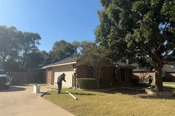 Roofing contractor working near staged gutters in DFW